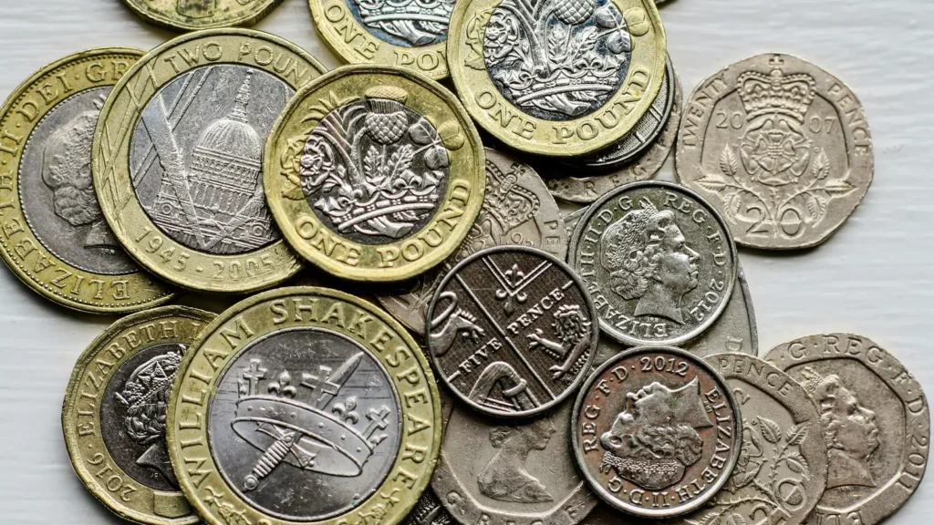 A pile of British coins on a table