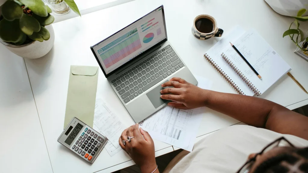 A person working on a laptop at a table