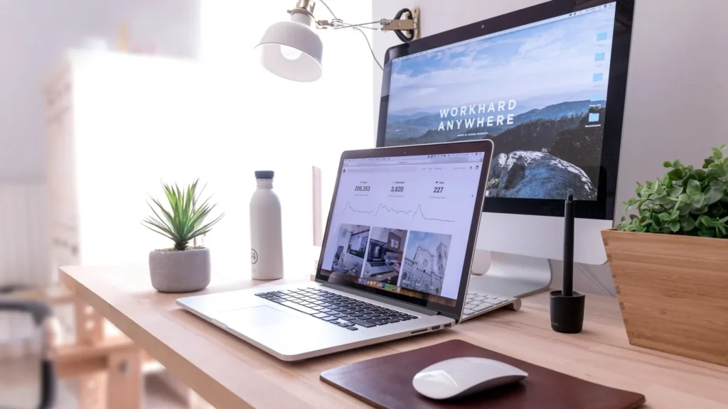A MacBook Pro beside an iMac on a desk