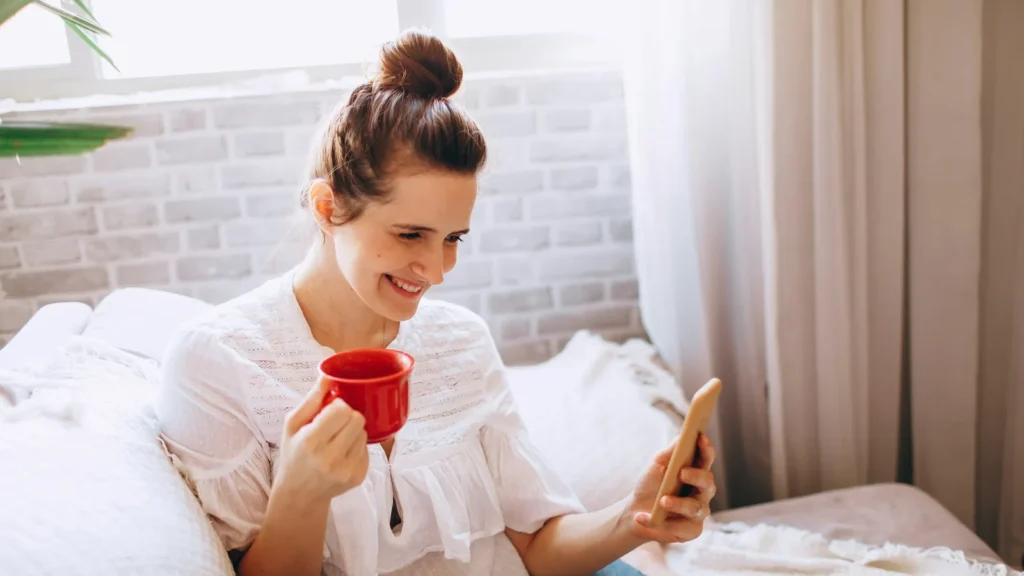 A woman holding a red mug